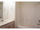 Clean bathroom featuring tub shower combo with neutral vanity and light fixtures at 6942 S Championship Dr, Chandler, AZ 85249
