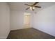 Spacious bedroom featuring neutral paint and carpeted floor with ceiling fan at 6942 S Championship Dr, Chandler, AZ 85249
