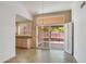 Bright dining area with chandelier lighting and sliding glass doors to backyard and view of adjacent kitchen at 6942 S Championship Dr, Chandler, AZ 85249