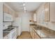 Well-lit kitchen featuring granite countertops, white appliances, and ample cabinet space at 6942 S Championship Dr, Chandler, AZ 85249