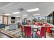 Spacious lounge area with comfortable seating, fireplace, large windows with a view of the community at 6942 S Championship Dr, Chandler, AZ 85249
