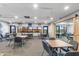Bright meeting room with multiple tables and chairs, large windows overlooking green areas and easy access to outdoors at 6942 S Championship Dr, Chandler, AZ 85249