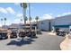 View of the parking lot next to the restaurant pro shop with golf cart parking and flag at 6942 S Championship Dr, Chandler, AZ 85249