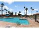 Inviting community pool area with lounge chairs and palm trees, perfect for relaxation and enjoying the sunny weather at 6942 S Championship Dr, Chandler, AZ 85249