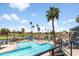 Overhead view of a community pool, deck area with lounge chairs, lush landscaping and golf course in the background at 6942 S Championship Dr, Chandler, AZ 85249