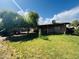 Spacious backyard with mature trees, lush lawn, and covered patio area, perfect for outdoor entertaining at 7141 W Denton Ln, Glendale, AZ 85303