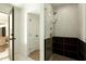 Shower room with floor to ceiling tiled walls, glass divider, and shower head at 8425 E Welsh Trl, Scottsdale, AZ 85258