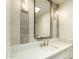 Bathroom showcases a white countertop with modern fixtures and tiled walls with a framed mirror at 8425 E Welsh Trl, Scottsdale, AZ 85258
