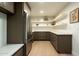 Butler's Pantry includes stainless steel refrigerator, white floating shelves, and plenty of cabinet space at 8425 E Welsh Trl, Scottsdale, AZ 85258