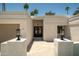 Inviting front entrance features double doors, warm lighting, and a charming brick pathway at 8425 E Welsh Trl, Scottsdale, AZ 85258