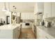 Spacious kitchen features white cabinets, stainless steel appliances, a large island, and modern pendant lighting at 8425 E Welsh Trl, Scottsdale, AZ 85258