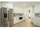 Modern kitchen features stainless steel refrigerator, white cabinets, and stylish backsplash at 8425 E Welsh Trl, Scottsdale, AZ 85258