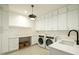 Spacious laundry room with built-in cabinets, countertop space, and modern washer and dryer units at 8425 E Welsh Trl, Scottsdale, AZ 85258
