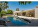 Backyard oasis showcasing a large pool, outdoor dining area, and inviting lounge chairs at 8425 E Welsh Trl, Scottsdale, AZ 85258