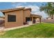 Spacious backyard with well-maintained lawn, covered patio, and ample space for outdoor activities at 1033 E Mountain Vista Dr, Phoenix, AZ 85048