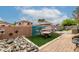 Backyard featuring a dining area, artificial grass, and rock landscaping at 1033 E Mountain Vista Dr, Phoenix, AZ 85048