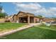 Expansive backyard featuring a covered patio, lush lawn, and a separate seating area at 1033 E Mountain Vista Dr, Phoenix, AZ 85048