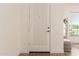 Clean and well lit entryway with white textured door and light wood flooring at 1033 E Mountain Vista Dr, Phoenix, AZ 85048