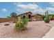 Front view of the house with desert landscaping and a two-car garage at 1033 E Mountain Vista Dr, Phoenix, AZ 85048