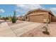 View of the house with a two-car garage and desert landscaping at 1033 E Mountain Vista Dr, Phoenix, AZ 85048