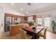 Eat-in kitchen with stainless appliances, wood cabinets, island, and access to the backyard at 1033 E Mountain Vista Dr, Phoenix, AZ 85048