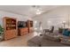 Comfortable living room with wood built-ins, a ceiling fan, and access to outdoor patio at 1033 E Mountain Vista Dr, Phoenix, AZ 85048