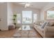 Bright living room with large windows, ceiling fan, and comfortable seating at 1033 E Mountain Vista Dr, Phoenix, AZ 85048