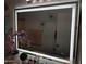 Bathroom mirror with lights, double sink and floral decorations and decor at 10407 W Reade Ave, Glendale, AZ 85307