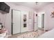 Cozy pink bedroom features a sliding closet with a mirrored door and colorful decor at 10407 W Reade Ave, Glendale, AZ 85307
