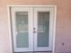 Patio double doors with glass windows with blinds that lead to outdoors at 10407 W Reade Ave, Glendale, AZ 85307