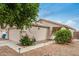 Front exterior view showcasing a tidy two-car garage, desert landscaping, and a welcoming entrance at 10407 W Reade Ave, Glendale, AZ 85307