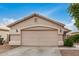 A well-maintained garage features a neutral color scheme and a clean concrete driveway under a bright blue sky at 10407 W Reade Ave, Glendale, AZ 85307