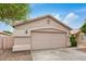 A tidy home exterior showcasing a garage, concrete driveway, and low-maintenance desert landscaping at 10407 W Reade Ave, Glendale, AZ 85307