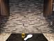 Kitchen backsplash with electric stovetop, granite countertop, and cooking utensils at 10407 W Reade Ave, Glendale, AZ 85307
