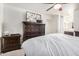 Spacious main bedroom with a dark wood dresser, mounted TV, and light walls at 10407 W Reade Ave, Glendale, AZ 85307
