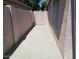 Cement patio area between a wall and building with a gated exit at 10407 W Reade Ave, Glendale, AZ 85307