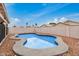 Backyard pool surrounded by stone and fencing, perfect for outdoor relaxation at 10407 W Reade Ave, Glendale, AZ 85307