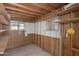Unfinished basement space with bare studs, shelving, and windows at 1053 S 96Th St, Mesa, AZ 85208