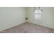 A compact bedroom with neutral carpet and window with a small shelf at 1053 S 96Th St, Mesa, AZ 85208