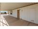 Covered carport space with white pillars, a concrete floor and entry door at 1053 S 96Th St, Mesa, AZ 85208
