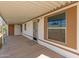 Covered carport features white siding, trimmed window and concrete floor at 1053 S 96Th St, Mesa, AZ 85208