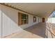A well-maintained, covered carport space with white pillars and a concrete floor at 1053 S 96Th St, Mesa, AZ 85208