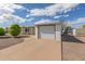 View of a home's driveway and garage, set against a blue sky and white clouds at 1053 S 96Th St, Mesa, AZ 85208