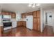 Functional kitchen featuring classic wooden cabinetry and white appliances at 1053 S 96Th St, Mesa, AZ 85208