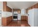 Functional kitchen featuring classic wooden cabinetry and white appliances at 1053 S 96Th St, Mesa, AZ 85208
