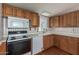 Functional kitchen featuring classic wooden cabinetry and white appliances at 1053 S 96Th St, Mesa, AZ 85208