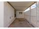 View of the carport's covered patio area with concrete floor, lattice, and window at 1053 S 96Th St, Mesa, AZ 85208