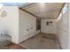 View of the carport's covered patio area with concrete floor, lattice, and window at 1053 S 96Th St, Mesa, AZ 85208