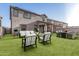 Large backyard with artificial grass, covered patio, and outdoor furniture at 10986 W Polk St, Avondale, AZ 85323