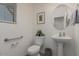 Bathroom featuring a pedestal sink, toilet, and decorative accents at 10986 W Polk St, Avondale, AZ 85323